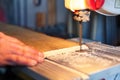 Carpenter Cutting a Piece Of Wood With Bandsaw In Workshop Royalty Free Stock Photo