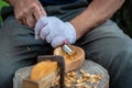 Craftsman demonstrates the process of making wooden spoons handmade using tools. National crafts concept. Royalty Free Stock Photo