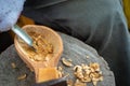 Craftsman demonstrates the process of making wooden spoons handmade using tools. Royalty Free Stock Photo