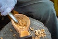 Craftsman demonstrates the process of making wooden spoons handmade using tools.