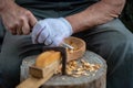 Craftsman demonstrates the process of making wooden spoons handmade using tools. Royalty Free Stock Photo