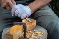 Craftsman demonstrates the process of making wooden spoons handmade using tools. National crafts concept. Royalty Free Stock Photo