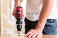 Craftsman or DIY man working with power drill Royalty Free Stock Photo
