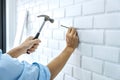 Craftsman doing renovation work at home improvement with using hammer to driving nail on brick wall and interior design concept Royalty Free Stock Photo