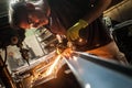 Craftsman with electric grinder tool on steel structure in factory Royalty Free Stock Photo