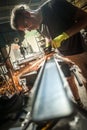 Craftsman with electric grinder tool on steel structure in factory Royalty Free Stock Photo