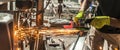 Craftsman with electric grinder tool on steel structure in factory Royalty Free Stock Photo