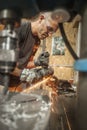 Craftsman with electric grinder tool on steel structure in factory Royalty Free Stock Photo