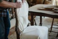 craftsman fitting a custom slipcover on an antique dining chair