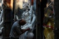 Craftsman giving final touches to Goddess Saraswati.