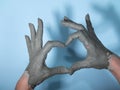 craftsman hands close up, kneads and moistens the clay before work. love sign made from fingers Royalty Free Stock Photo