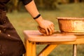 Craftsman hands kneads clay for making pottery bowl. Man working on potter wheel Royalty Free Stock Photo