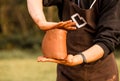 Craftsman hands kneads clay for making pottery bowl. Man working on potter wheel Royalty Free Stock Photo