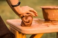 Craftsman hands kneads clay for making pottery bowl. Man working on potter wheel Royalty Free Stock Photo