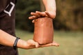 Craftsman hands kneads clay for making pottery bowl. Man working on potter wheel Royalty Free Stock Photo