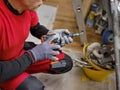 Craftsman holding a screwdriver drill ready to perform home renovation. Worker in work clothes on a construction site on an Royalty Free Stock Photo