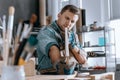 Craftsman holding wooden board