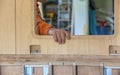 Craftsman holding a wooden door in a workshop