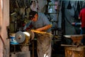 Craftsman honing or sharpening a blade on the machine.