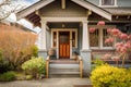 craftsman house exterior with front porch, wooden swing and lantern, and blooming flowers