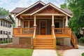 craftsman house with newly constructed porch, featuring wooden steps and railing Royalty Free Stock Photo