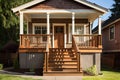 craftsman house with newly constructed porch, featuring wooden steps and railing Royalty Free Stock Photo