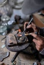 A craftsman jeweler is using a blowtorch to create a metal cilinder for a bracelet Royalty Free Stock Photo