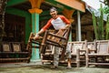 a craftsman lifts a shiny polished bamboo chair Royalty Free Stock Photo