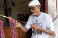 Craftsman weaving bracelets, Bali, Indonesia