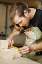 Craftsman measure wooden planks with ruler. Woodworker at workshop Royalty Free Stock Photo