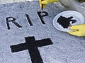 Craftsman paints a tombstone halloween