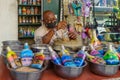 Craftsman preparing glass bottles with colorful sand, in Aqaba