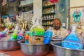 Craftsman preparing glass bottles with colorful sand, in Aqaba