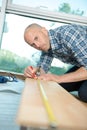 craftsman putting wooden floor in room