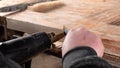 craftsman removes the old paint from the wooden door spatula and industrial heat gun, restoration of an old wooden