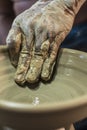 Craftsman\'s hand creating the art of ceramics in a pottery. Maragogipinho, Bahia, Brazil