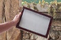 Craftsman's hands holding a wooden frame with vegetable fibers