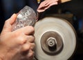 Craftsman during sanding of a crystal ashtrays