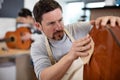 craftsman sanding guitar Royalty Free Stock Photo