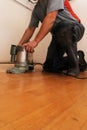 craftsman sanding a parquet floor