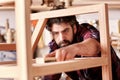 Craftsman sanding a wooden item in his woodwork studio Royalty Free Stock Photo