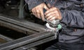 Craftsman sawing metal with disk grinder in workshop. Grinding metal with sparks flying Royalty Free Stock Photo