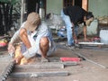 The craftsman sawing metal with grinder in workshop