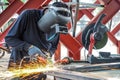 Craftsman sawing metal sparkles all around workshop. Working at noon Royalty Free Stock Photo