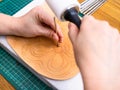 Craftsman stamps the floral ornament on leather