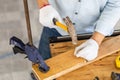 Craftsman using hammer hobnailed in workshop, Carpenter using the hammer hit a nail for assembly wood in a carpentry workshop Royalty Free Stock Photo
