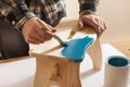 Craftsman varnishing and handmade stool
