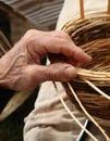 Craftsman weaves a wicker basket