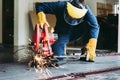 Craftsman Welding is Cutting Steel Work, Welder Man in Safety Protective Equipment Doing Metalwork in Construction Site. Royalty Free Stock Photo