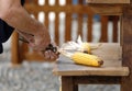 Craftsman who intersects the leaves of a corn cob